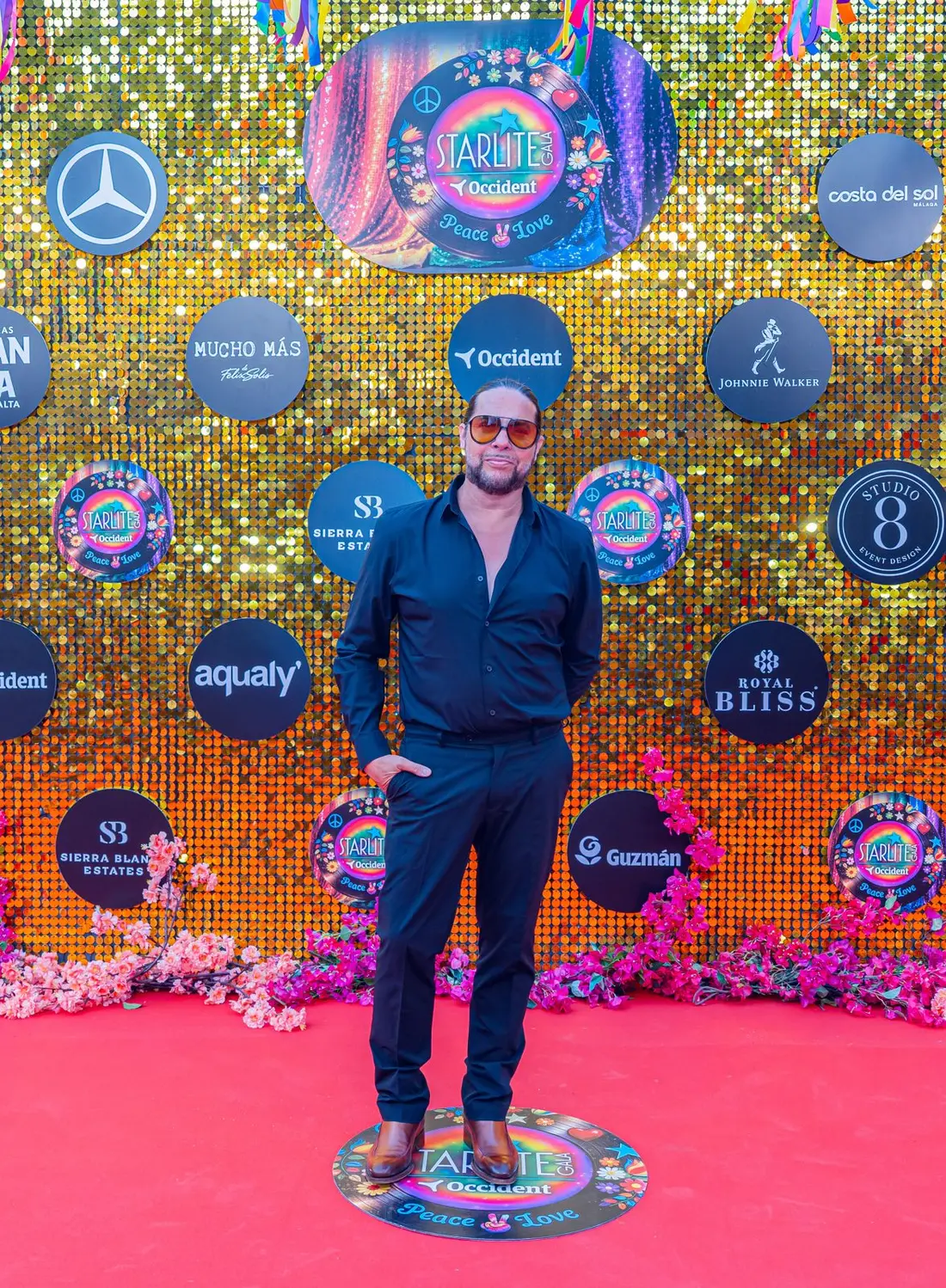 Joaquín Cortés at the photocall of the XVII Starlite Occident Gala, against the Peace & Love backdrop